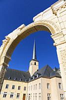 Europe, Luxembourg, Luxembourg City, Church of Saint John in Grund and the Neimënster Cultural Centre framed by Reproduction of ancient Stone Archway.