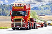 Scania truck of PHP Group in front of gooseneck trailer returns from delivering oversize load, followed by escort vehicle. Salo, Finland. May 15, 2021...