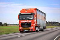 Orange Mercedes-Benz Actros truck of Fehrenkötter GmbH, Germany, pulling special trailer on road. Exceptional load. Marttila, Finland. May 14, 2021.