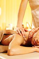 Woman having massage in the spa salon.