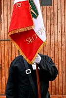 A French army veteran carries the French flag-la Trois Couleurs- at a commemoration ceremony honoring the dead of the war in Algeria..  