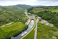 Aerial view from drone of Crinan Canal at village of Cairnbaan in Argyll & Bute, Scotland, UK.
