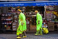 Kyoto, Japan, Asia - An elderly couple wearing bright matching outfits in front of a liquor market in the city centre.