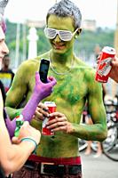 contemporary lifestyle, man´s body painted in green colour in company of other men drinking beer, taken during Lake Parade - LGBT Parade, Pride Parade...