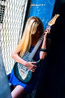 Blonde teen girl with an electric guitar hidden face captivity