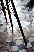 traditional design old broken floor tiles detail in trendy Ibiza cafe interior.