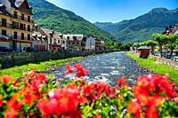 Garona river crossing the Pyrenean village of Bosost, located in the Aran Valley, Spain.