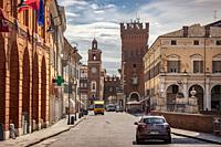 FERRARA, ITALY 29 JULY 2020 : Evocative view of the road leading to the historic center of Ferrara with a view of the castle and life on the road.
