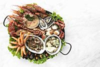 mixed fresh mediterranean seafood gourmet platter on spanish restaurant table in barcelona.
