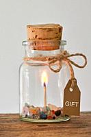 Abstact Gift. Jar with Match Stick Ignited Burning Fire Flame and Precious Stones.