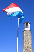 Europe, Luxembourg, Wiltz, Memorial Tower â. œNationales Streikdenkmalâ. . with the National Flag of Luxembourg.