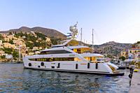 Superyacht moored at Gialos harbour, Symi Island, Greece.