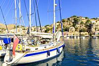 Moored yachts in Gialos harbour, Symi Island, Dodecanese, Greece.