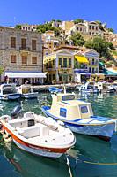 Small fishing boats along the waterfront of Symi Town, Gialos, Symi Island, Dodecanese, Greece.