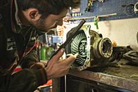 MILAN, ITALY: Mechanic repairs the gearbox.
