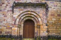 Romanesque facade of San Juan church. San Juan de Raicedo, Cantabria, Spain.