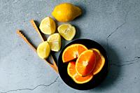 Orange and lemons cut in black bowl
