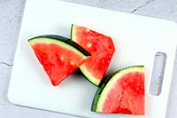 Watermelon slices on cooking board