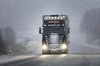 Customised Scania truck of Stengel LT pulls trailer along Finnish national road 52 in winter snowstorm. Salo, Finland. November 29, 2019.
