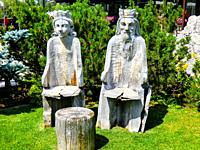 Carved wooden chairs representing a king and a Queen in Val d Ega, Eggen valley, summer 2021, South Tyrol, Italy, Europe.