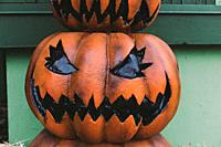 A Halloween decorative dark colored Jack-o-Lantern pumpkin on the street. Halloween and carnival celebration concept.