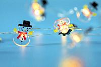 Happy Snowman lights on blue background, Winter and Christmas concept with copy space retro design glowing lights.