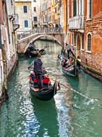 three Gondolas passing under Ponte de la Cortesia, Rio de San Luca, Venice, ItalyVenice, Italy.