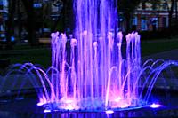 Blue fountains in city park. Colorful jets of water . Lifestyle concept.