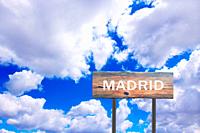 Sign with inscription Madrid with view of sky. Pointer of the settlement. Road sign indicating settlement. Sign about Madrid on blue and cloudy sky ba...