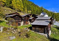 Wooden stables and storage houses in the hamlet Kühmad near the pilgrimage chapel, view at the Loetschenluecke Pass, Blatten, Lötschental, Valais, Swi...