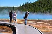 Tourists On Grand Prismatic Spring In Yellowstone National Park, Wyoming, USA.