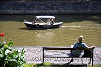 Family in electric boats for rent in the River Aura in Turku Finland.