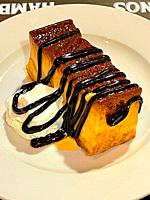Pudding with chocolate syrup and cream. Spain.