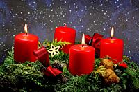 . advent wreath with 3 burning candles.