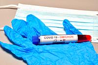 Blood tube for test detection of virus Covid-19 Omicron Variant with positive result and protection masks and gloves. Concept of protection for new va...