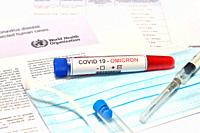 Blood tube for test detection of virus Covid-19 Omicron Variant with positive result on protection mask and document. Concept of protection from new v...