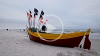Fishing boat on a beach in Debki village over Baltic Sea in Poland