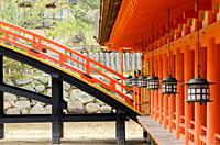 Lanterns and wooden bridge at the main temple of Itsukushima Shrine in Miyajima, Japan.