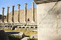 Tourists walking in front of the marble columns of ancient medicinal sanctuary of Asklepion near Bergama Town, Izmir Province, Aegean Region, Turkey, ...