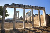 Tourists in front of the marble columns and rests of The Sanctuary of Trajan at Bergama Archaeological site of ancient Pergamon city, Bergama Town, Iz...