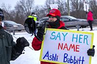 Rochester Hills, Michigan USA - 6 January 2022 - A counter-demonstrator at a rally protesting the violent attack on the U. S. Capitol a year earlier. ...