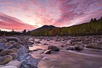 Black Mountain from along the East Branch of the Pemigewasset River, near the Loon Mtn. bridge, in Lincoln, New Hampshire at sunrise on an autumn day.