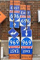 Madison Heights, Michigan - Road signs and barriers for a highway construction project stored along an interstate highway in suburban Detroit.