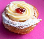 Zeppole of Saint Joseph, Italian pastry with flour, sugar, eggs, oil, decorated with a sour cherry. Father's Day cake.