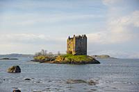 Castle Stalker, in the middle of a lake, sunny day, green, blue and yellow, Fott William, Highlands, Scotland.