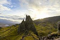 Old Man of Sotrr, big cliff, cloudy day, sun rays, mountain landscape, Skye Island, Highlands, Scotland.