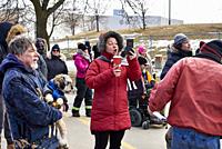 A woman protester makes a live feed on social media at a police barrier on 12 February 2022 near the Freddom Convoy blockade of the Ambassador Bridge ...