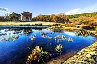 Frozen pond and St. Isidro hermitage in Sierra de Gredos. Avila. Spain. Europe.