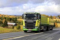 New, green Scania R650 truck of Kuljetus Saarinen Oy in seasonal sugar beet haul on scenic autumnal road in Salo, Finland. October 12, 2019.