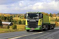 New, green Scania R650 truck of Kuljetus Saarinen Oy in seasonal sugar beet haul on scenic autumnal road in Salo, Finland. October 12, 2019.